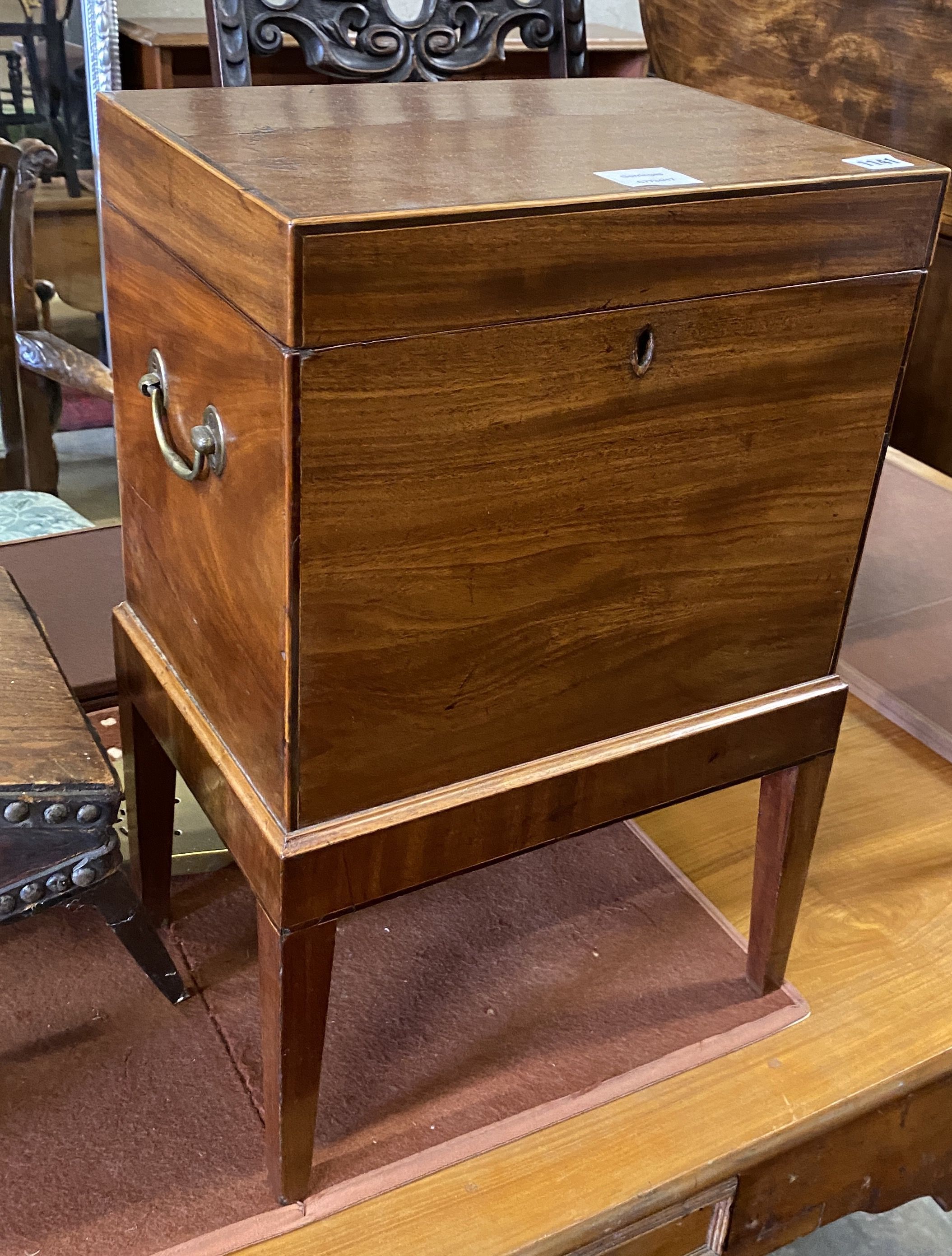 A George III mahogany cellarette, raised on square tapered legs, width 38cm, depth 27cm, height 56cm